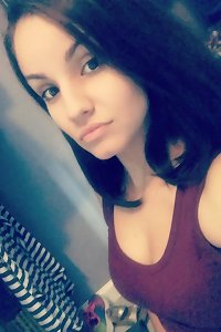 Big, buxomy female in lingerie, playfully posing on sofa